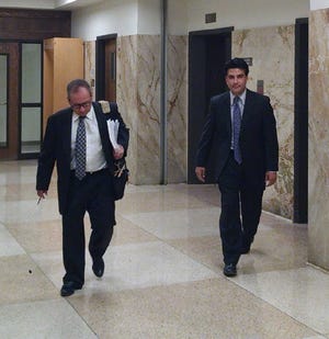 Lubbock attorney Rod Hobson, left, and Erik Medina walk Thursday to the Lubbock County Court at Law 1 courtroom to appear before Judge Dan Schaap. Medina entered guilty pleas to seven counts of practicing medicine without a license in exchange for a 10-year deferred adjudication sentence.