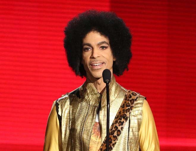 FILE - In this Nov. 22, 2015 file photo, Prince presents the award for favorite album - soul/R&B at the American Music Awards in Los Angeles. Authorities are investigating a death at Paisley Park, where pop superstar Prince has his recording studios. Jason Kamerud, Carver County chief sheriff’s deputy, tells the Minneapolis Star Tribune that the investigation began on Thursday morning, April 21, 2016. (Photo by Matt Sayles/Invision/AP, File)