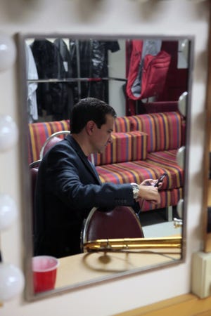 International Portuguese Music Awards organizer David Saraiva checks his messages before the start of the 2015 show at the Zeiterion Theatre. 

MICHAEL SMITH/STANDARD-TIMES SPECIAL FILE/SCMG