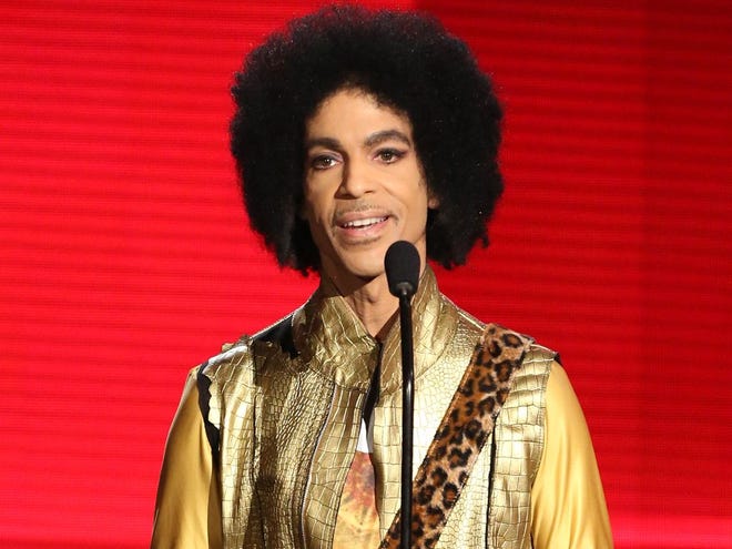 In this Nov. 22, 2015, file photo, Prince presents the award for favorite album - soul/R&B at the American Music Awards in Los Angeles. The Associated Press