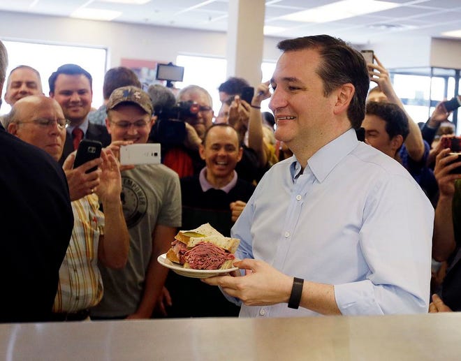 Republican presidential candidate, Sen. Ted Cruz, R-Texas holds his sandwich during a campaign stop at Shapiro's Delicatessen, Thursday, April 21, 2016, in Indianapolis. (AP Photo/Darron Cummings)