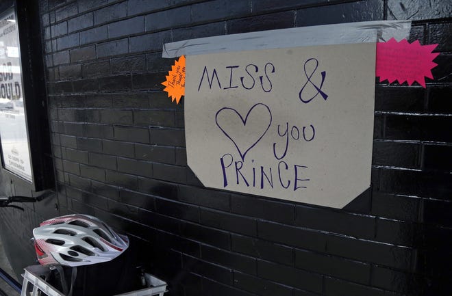 A home made sign is attached to the wall in memory of Prince at First Avenue Friday, in Minneapolis where he often performed. The pop super star died Thursday at the age of 57. JIM MONE/AP PHOTO