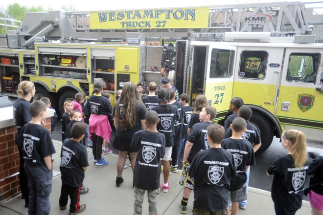 Westampton firefighter Jeff DeAngelis shows the cadets of the Burlington County Youth Police Academy the company's ladder truck at the county Human Services Building in Westampton on Saturday, April 23, 2016. The academy serves children ages 7 and 12.