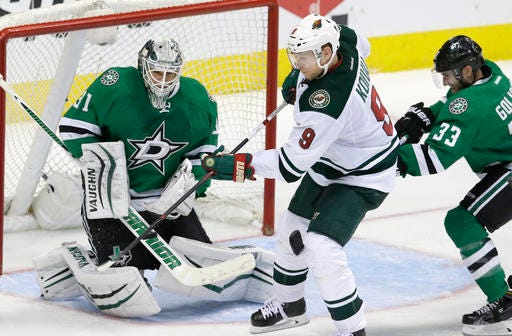 Minnesota Wild center Mikko Koivu (9) scores a goal against Dallas Stars goalie Antti Niemi (31) and defenseman Alex Goligoski (33) during overtime in Game 5 in the first round of the NHL Stanley Cup playoffs Friday, April 22, 2016, in Dallas. The Wild won 5-4. (AP Photo/LM Otero)