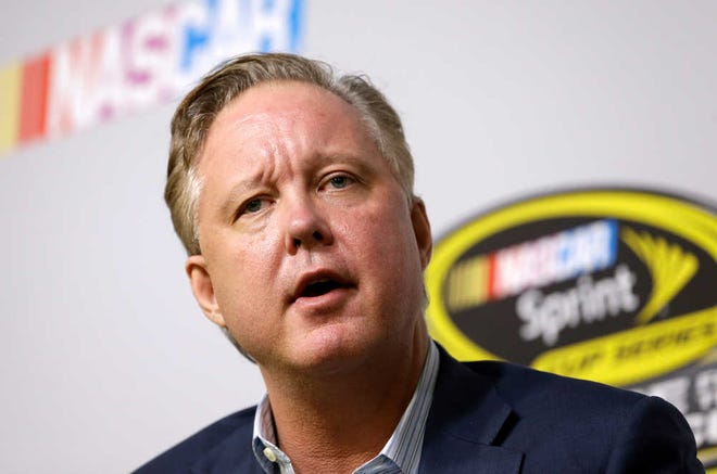 FILE - In this Nov. 20, 2015, file photo, Brian France, NASCAR Chairman and CEO, talks to reporters at a news conference during NASCAR Championship auto racing weekend at Homestead-Miami Speedway in Homestead, Fla. At a time when other sports are leading the charge toward a brighter social future, the good ol' boys seem intent on returning us to a more divisive era. (AP Photo/Alan Diaz, File)