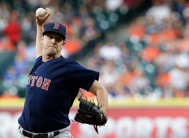 Boston Red Sox's Steven Wright delivers a pitch against the Houston Astros during the first inning of a baseball game Friday, April 22, 2016, in Houston. (AP Photo/Pat Sullivan)