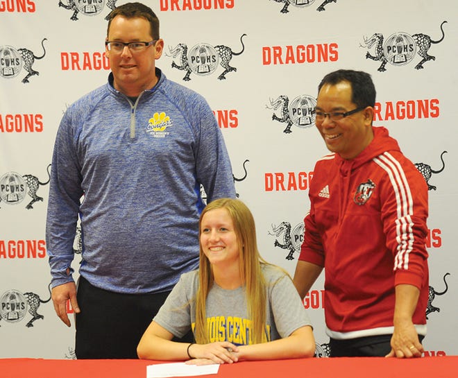 Pekins Audrey Duley signed to play soccer at Illinois Central College. ICC head coach William Hudson (left) and Pekin head coach Edgar Sandoval (right) joined Duley and roughly 30 friends and family at Pekin 
Community High School Friday.