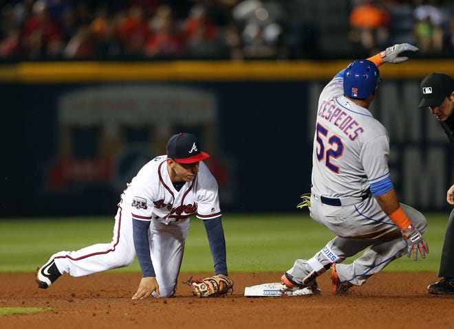 Mets' Yoenis Cespedes is safe at second with an RBI double as Braves shortstop Daniel Castro, left, handles the throw in the seventh inning of Friday night's game in Atlanta. The Associated Press