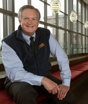 University of Massachusetts Dartmouth interim Chancellor Randy Helm is seen in the new section of the Carney Library, with the familiar UMD architecture seen behind him.