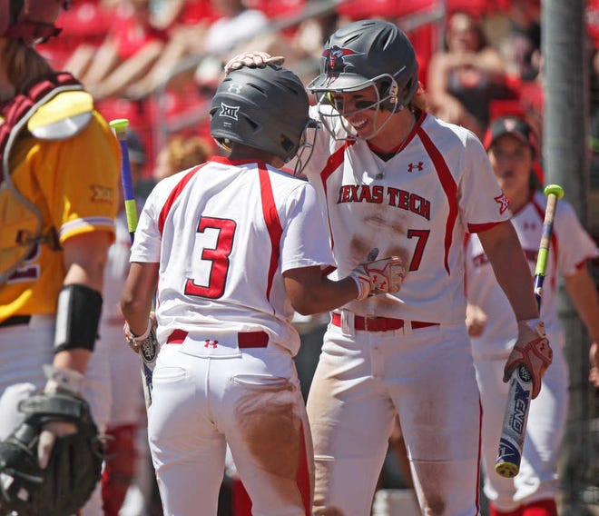Texas Tech's Jessica Hartwell celebrates with teammate Kiani Ramsey after Ramsey crossed home plate in the first inning of the Red Raiders' game against Ohio State on Sunday, April 24, 2016.