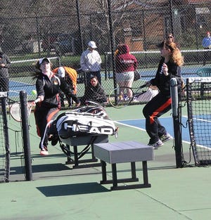 Courtney O'Brien returns a shot for a point at second doubles behind partner Zoe Yoquelet on Saturday.