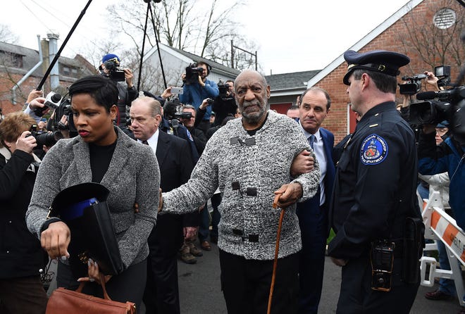 (File) Bill Cosby is led to a waiting car from his arraignment flanked by attorneys Monique Pressley and Brian J. McMonagle on Wednesday, Dec. 30, 2015, at the office of District Judge Elizabeth McHugh in Elkins Park.
