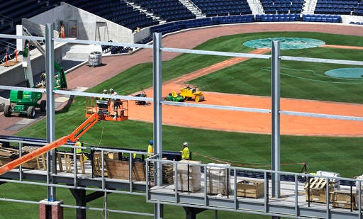 Construction workers build the right field wall at a stadium for Hartford's new minor league baseball team in Hartford, Conn., Monday, April 25, 2016. Almost a month into the baseball season, Eastern League President Joe McEacharn says he won't set an opening day until he's knows the team's delayed and over-budget $65 million stadium is 100 percent ready for play. (AP Photo/Charles Krupa)
