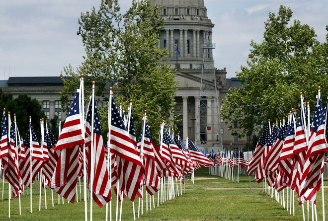 During the month of April, National Child Abuse Prevention Month, the lawn on the south side of the state Capitol is covered with rows of American flags, numbering in the hundreds, to represent the children that died as a result of abuse and neglect during the previous year. A special section of Oklahoma flags represent Oklahoma children that died during the same year. The "Field of Flags" is a project of the Exchange Clubs of Oklahoma City. [Photo by Jim Beckel, The Oklahoman Archives]