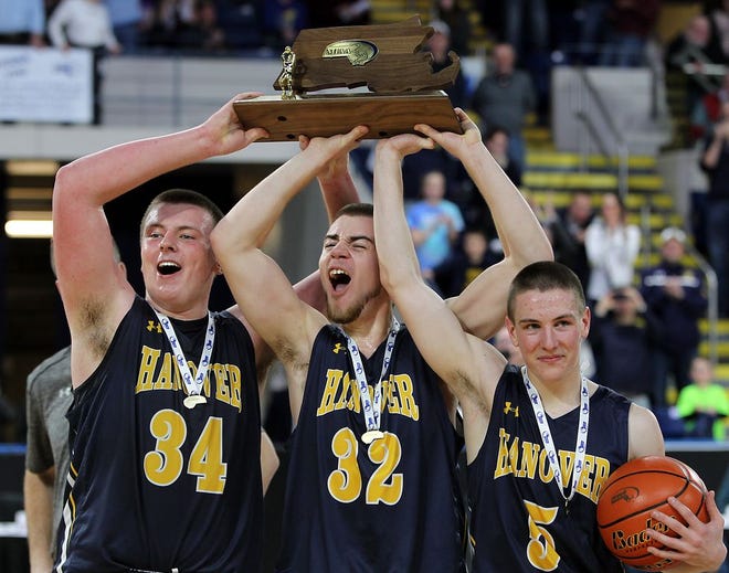 Hanover's Patrick Flynn, Fredrick Damon, and Zachary Chase lift the state title trophy for Division 3 boys basketball after their 58-43 win over Palmer in the Division 3 state title game at the MassMutual Center on Saturday, March 18, 2017.