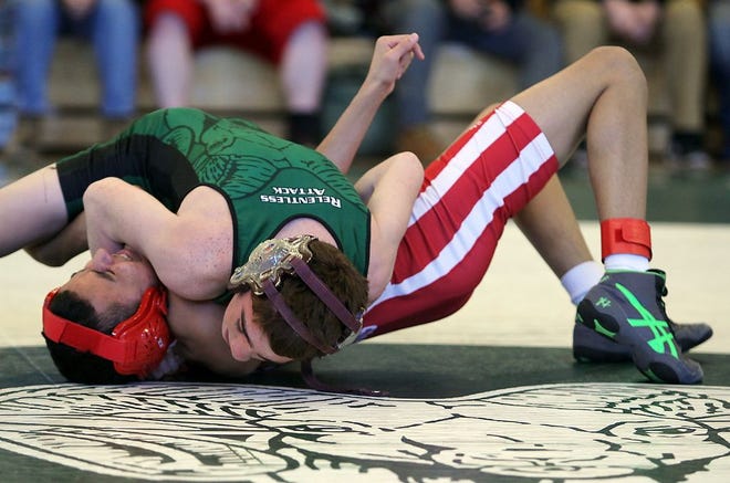 Marshfield's Jacob Garcia (106 lbs) has a hold of Milton's Mark Labelle in the opening round of the Division 2 wrestling tournament at Marshfield High School on Friday, Feb. 19, 2016. Wicked Local Staff Photo/ Robin Chan