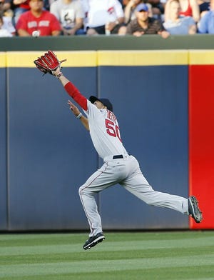 Boston Red Sox right fielder Mookie Betts makes a leaping catch to retire Atlanta Braves' A.J. Pierzynski in the first inning of a baseball game Monday, April 25, 2016, in Atlanta.