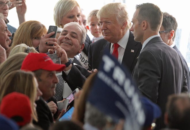 Donald Trump meets supporters as he takes the stage under a big tent at the Crowne Plaza in Warwick Monday. About 800 people filled event. The Providence Journal/Steve Szydlowski