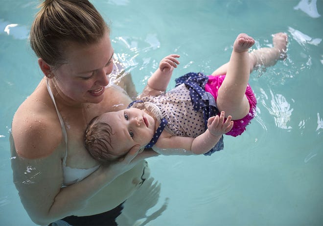 Holly Asnen, of Newtown Township, holds daughter Olivia, 6 months, in the pool during an infant swimming lesson at The British Swim School in Richboro on Friday, April 15, 2016.