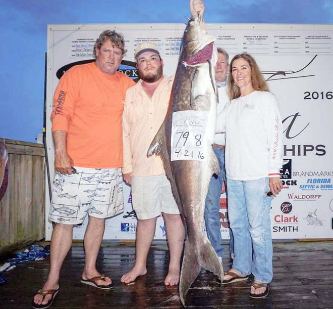 Pam Dana, right, leads the Ladies World Championships with this 79.8-pound cobia caught on the Sure Lure with Capt. Don Dineen and crew.