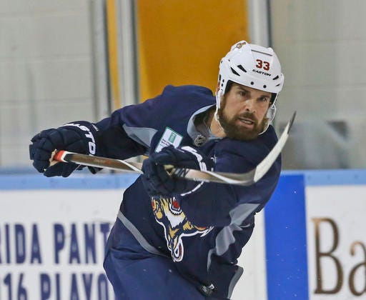 FILE - In this April 12, 2016 file photo, Florida Panthers defenseman Willie Mitchell takes a shot during a practice session, in Coral Springs, Fla. The Florida Panthers do not expect captain and two-time Stanley Cup winner Willie Mitchell to return next season, and one of his closest friends indicated that his career is over. Mitchell missed the final 42 games this season, amid concern over what another concussion would do to his long-term health. (AP Photo/Wilfredo Lee, File)