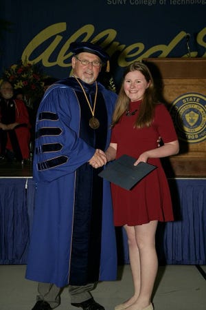 Mikalyn Kommer, right, accepts the Sigma Tau Epsilon Award at Alfred State College. PHOTO PROVIDED/MIKE KOMMER