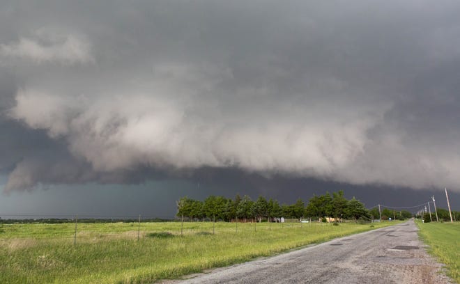In this May 31, 2013 file photo, a tornado forms near Banner Road and Praire Circle in El Reno, Okla. Forecasters are finding that the human mind is more difficult to predict than a stormy atmosphere. As the nation's midsection braces for bad weather today, researchers are still trying to determine when to raise a general alarm with the public, so warnings will be more effective. The National Weather Service has even brought on a social scientist to help. (AP Photo/Alonzo Adams, File)