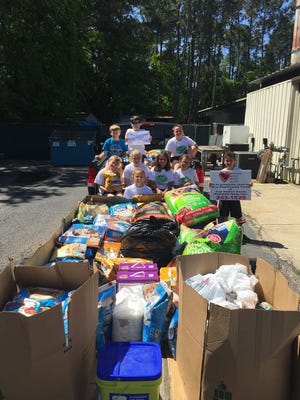 The RAKK club students at DES donated 2,577 pounds of pet food to PAWS this past Saturday.