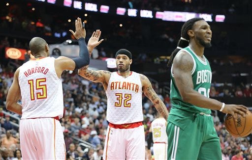 Atlanta Hawks Al Horford, from left, gets five from Mike Scott after drawing a foul from Boston Celtics Jae Crowder on the way to the basket during the second half in Game 5 of an NBA basketball first-round playoff series at Philips Arena on Tuesday, April 26, 2016, in Atlanta. Hawks won 110-83. (Curtis Compton/Atlanta Journal-Constitution via AP) MARIETTA DAILY OUT; GWINNETT DAILY POST OUT; LOCAL TELEVISION OUT; WXIA-TV OUT; WGCL-TV OUT; MANDATORY CREDIT
