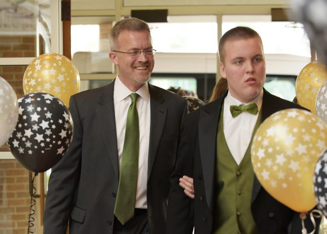 Ben Mason, 20, the namesake of nonprofit Benjamin's Hope, walks the red carpet of his first prom with his dad, Dave Mason, on Sunday, April 24, at Beechwood Church, 895 Ottawa Beach Road in Park Township. Contributed