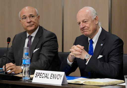 FILE-- In this Fiday April 22, 2016, file photo, UN special envoy for Syria envoy Staffan de Mistura, right, and his deputy Ramzy Ezzeldin Ramzy attend a meeting with the Syrian government delegation during Syria peace talks at the United Nations office in Geneva, Switzerland. A military buildup in northern Syria coupled with heavy fighting and mounting civilian casualties spells the end of a cease-fire that for two months brought much needed relief to war-stricken Syrians, ushering in what could be an even more ruinous chapter in the country's five-year-old conflict. (Fabrice Coffrini/Pool Photo via AP, File)