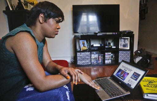 Jay Blessed, who listened to various unlicensed stations when she moved from Trinidad to Brooklyn more than a decade ago and broadcasted her own online radio show, prepare to update her blog she says will interface with her new podcast program, Sunday, April 24, 2016, in New York. Federal lawmakers and broadcasters are increasingly worried about pirate radio's presence in some cities as unlicensed broadcasters commandeer frequencies to play anything.