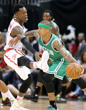 Celtics guard Isaiah Thomas drives against Atlanta Hawks guard Dennis Schroeder during the first half of Game 5 on Tuesday night. AP Photo