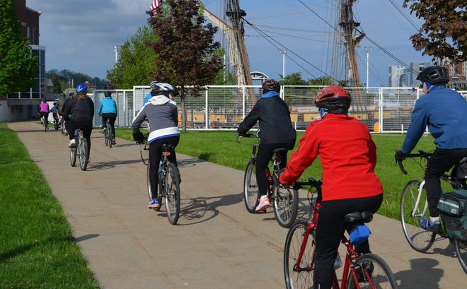 Bike Around the Bay participants ride by the Brig Niagara in 2014. CONTRIBUTED PHOTO/