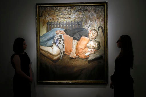Christie's employees look towards a family portrait from 1992 by Lucian Freud, at their auction rooms in London, Thursday, April 28, 2016. The painting valued at 18 million UK pounds (26.25 million US dollars) will be auctioned on June 30 in the Defining British Art sale. (AP Photo/Kirsty Wigglesworth)