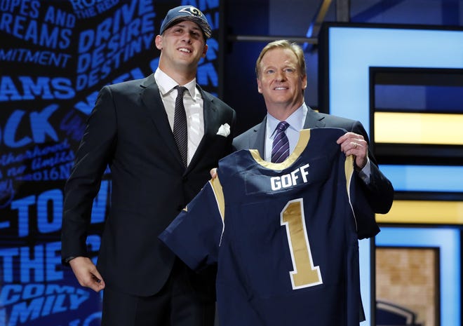 California's Jared Goff poses for photos with NFL commissioner Roger Goodell after being selected by the Los Angeles Rams as the first pick in the first round of the 2016 NFL football draft, Thursday, April 28, 2016, in Chicago. (AP Photo/Charles Rex Arbogast)