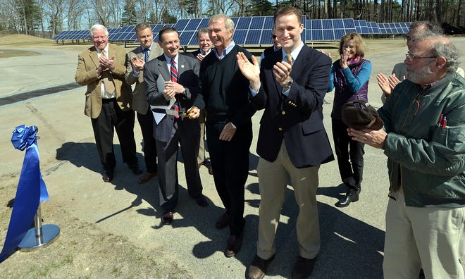 All applaud after Medfield energy committee chairman Fred Bunger, center cut the ribbon at Medfield's waste water treatment facility. To the right of him is energy and facilities manager Andrew Seaman and to the left is Mark Fisher, chairman of the board of selectmen.

Wicked Local Staff Photo/ Allan Jung