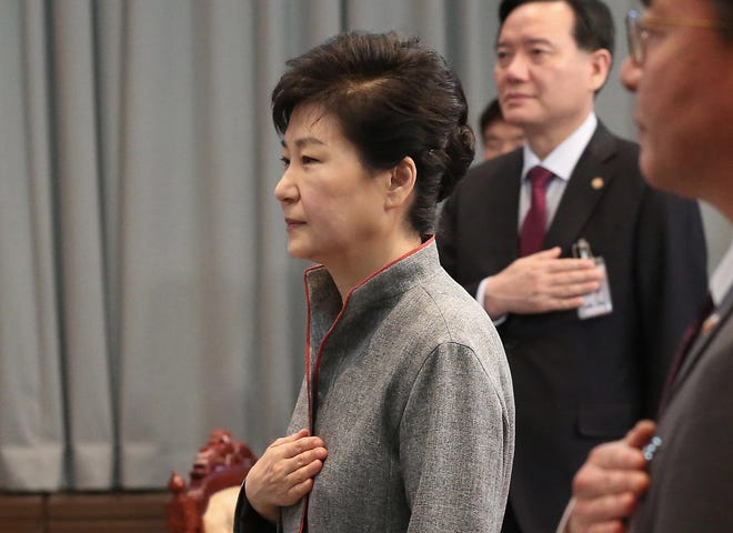 South Korean President Park Geun-hye, left, salutes to the national flag during the National Security Council Meeting at the presidential house in Seoul, South Korea, Thursday, April 28, 2016. A suspected powerful intermediate-range North Korean missile crashed moments after liftoff Thursday, South Korea's Defense Ministry said, in what would be the second such embarrassing failure in recent weeks. Park said Thursday there were unspecified signs that a fifth test was "imminent." She warned another nuclear test would result in North Korea suffering harsher sanctions. (Lee Sang-hack/Yonhap via AP) KOREA OUT