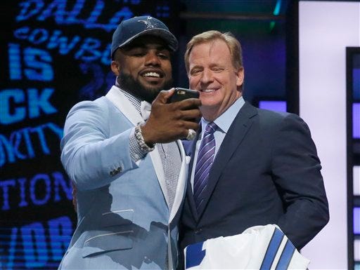 Ohio State"™s Ezekiel Elliott takes a selfie with NFL commissioner Roger Goodell after being selected by Dallas Cowboys as the fourth pick in the first round of the 2016 NFL football draft, Thursday, April 28, 2016, in Chicago. (AP Photo/Charles Rex Arbogast)