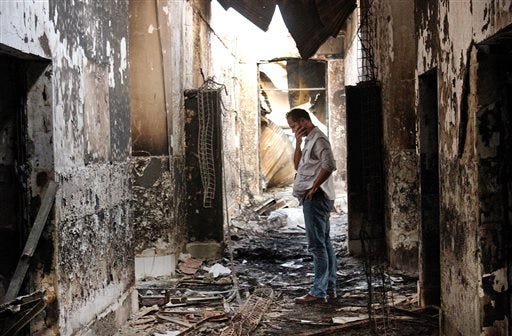 FILE - In this Oct. 16, 2015, file photo, an employee of Doctors Without Borders walks inside the charred remains of the organization's hospital after it was hit by a U.S. airstrike in Kunduz, Afghanistan.