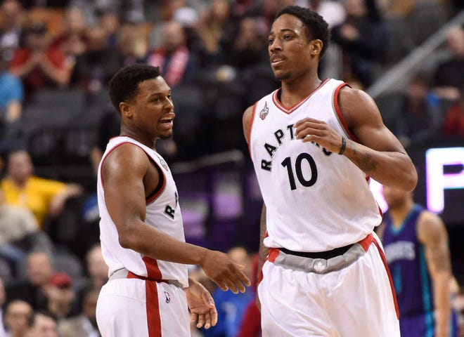 Toronto Raptors' DeMar DeRozan (10) celebrates his basket in the last minute against the Charlotte Hornets, with teammate Kyle Lowry, at an NBA basketball game Tuesday, April 5, 2016, in Toronto. (Frank Gunn/The Canadian Press via AP)