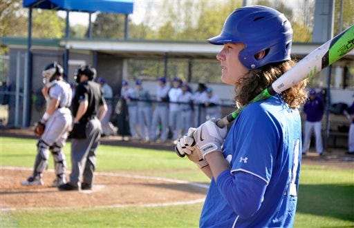In this Monday, April 11, 2016 photo, Rogers High School’s Harrison Heffley waits on deck during a game against Fayetteville at Veteran’s Park in Rogers, Ark. Heffley, who has signed to play baseball at Arkansas next season in college, is one of a shrinking number of high school athletes who have chosen to play multiple sports as opposed to specializing. (AP Photo/Kurt Voigt)
