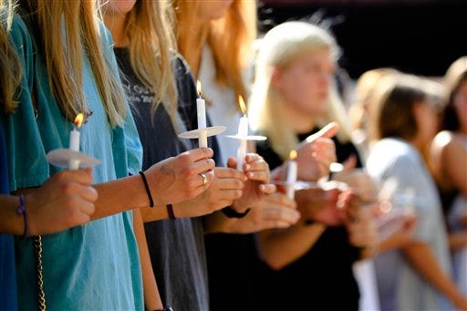 April 28, 2016 Athens - Students hold candles University of Georgia students, faculty and family members hold candles to mourn the deaths of Georgia students killed in a car crash late Wednesday night, during a vigil in Athens, Ga., Thursday, April 28, 2016. Oconee County Sheriff Scott Berry told local news outlets the crash occurred just outside Watkinsville when two mid-sized sedans, one driving northbound and the other southbound, collided on Georgia State Route 15. (Taylor Carpenter/Atlanta Journal-Constitution via AP) MANDATORY CREDIT