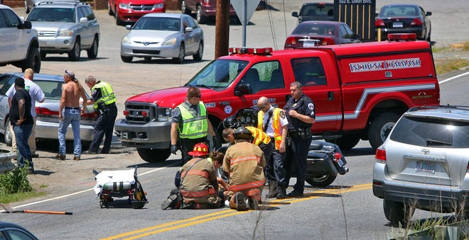 Emergency personnel work on the scene of a wreck involving a motorcycle and a car at the intersection of Earl Road and East Dixon Boulevard in Shelby on Friday. Brittany Randolph/The Star