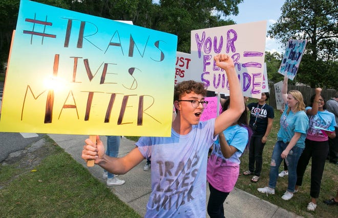 Nich Rardin, an 11th grader at Vanguard High School, center, coordinated the Transgender Lives Matter protest Friday. About 50 students protested Friday afternoon, April 29, 2016, outside the grounds of Vanguard High School on the decision by the Marion County School Board after they decided Tuesday evening, to limit transgender students to bathrooms associated with their birth sex, not their gender identity.