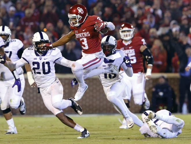 Oklahoma wide receiver Sterling Shepard (3) leaps to avoid TCU linebacker Montrel Wilson (20) and others during a game last season. Shepard had 86 receptions for 1,288 yards and 11 touchdowns for the Sooners. The Associated Press