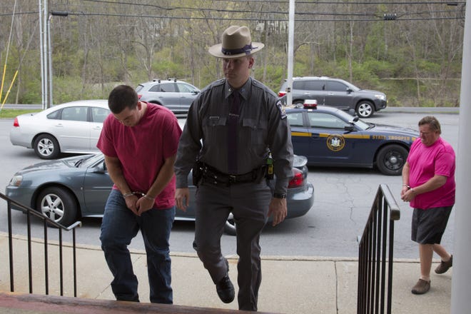 New York State Police escort men and women arrested in predawn drug raids into Warwick Town Court on Thursday afternoon for their arraignment. The police frequently use early morning raids as a tried-and-true strategy for safety. ROBERT G. BREESE/FOR THE TIMES HERALD-RECORD