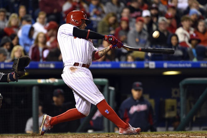 Philadelphia Phillies' Freddy Galvis hits an RBI single to score David Lough off Cleveland Indians relief pitcher Joba Chamberlain during the seventh inning of a baseball game, Saturday, April 30, 2016, in Philadelphia. The Phillies won 4-3. (AP Photo/Derik Hamilton)