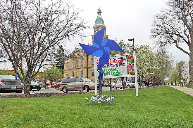 A large blue pinwheel was placed on the lawn of the Hillsdale County Courthouse in early April to show support for Child Abuse Awareness Month. The pinwheel serves as the national symbol for child abuse prevention. COREY MURRAY PHOTO