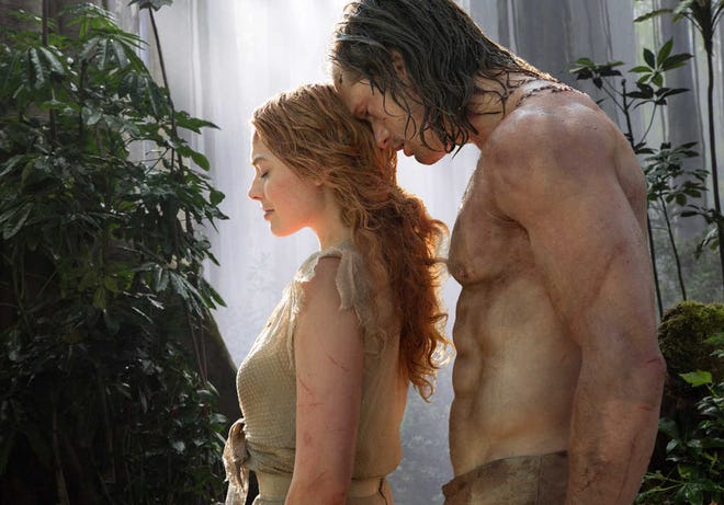 This image released by Warner Bros. Entertainment shows Margot Robbie as Jane, left, and Alexander Skarsgard as Tarzan in a scene from, "The Legend of Tarzan." (Jonathan Olley/Warner Bros. Entertainment via AP)